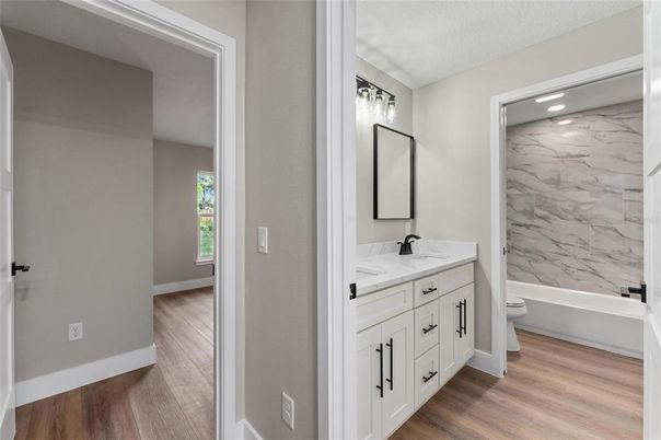 Bathroom, Dual Sink Vanities, Interior, Marble Walls, Recessed Lighting, Wood Texture Flooring