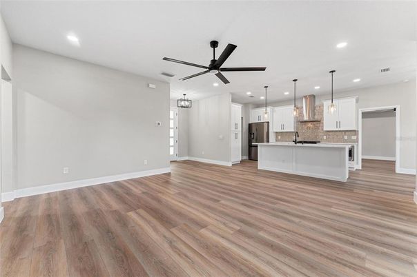Empty room, Interior, Kitchen, Pendant Lights, Recessed Lighting, Stainless Steel Appliances, Wood Texture Flooring