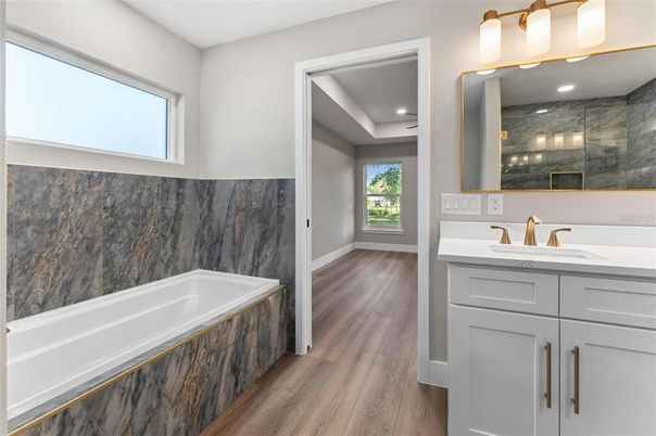 Bathroom, Dual Sink Vanities, Interior, Marble Walls, Recessed Lighting, Wood Texture Flooring