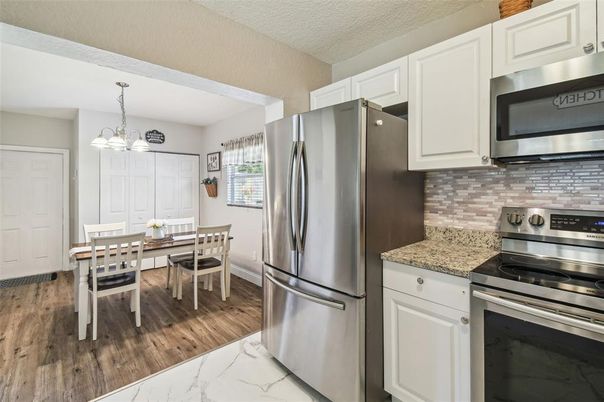 Chandelier, Dining room, Interior, Kitchen, Pendant Lights, Stainless Steel Appliances, Wood Texture Flooring
