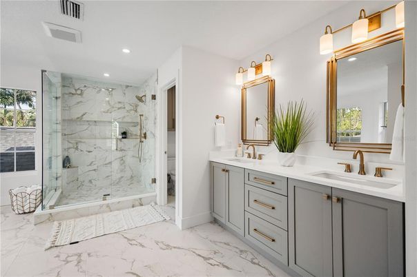 Bathroom, Dual Sink Vanities, Glass Shower, Interior, Marble, Marble Walls, Recessed Lighting