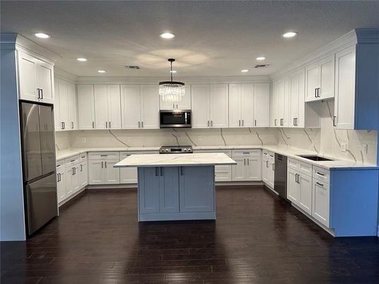 Chandelier, Interior, Kitchen, Marble Walls, Pendant Lights, Recessed Lighting, Stainless Steel Appliances, Wood Texture Flooring