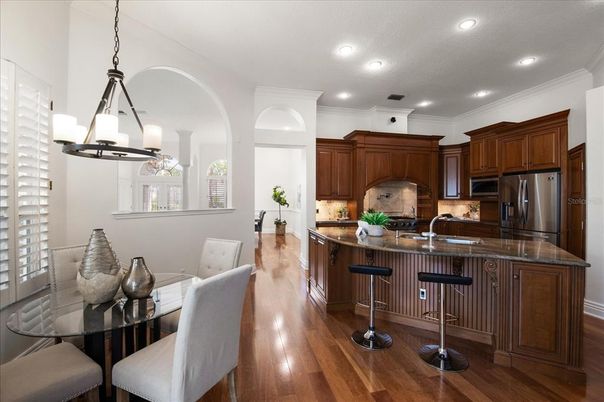 Chandelier, Dining room, Interior, Kitchen, Pendant Lights, Recessed Lighting, Stainless Steel Appliances, Wood Texture Flooring