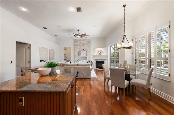 Chandelier, Dining room, Fireplace, Interior, Living room, Pendant Lights, Recessed Lighting, Stone Walls, Wood Texture Flooring