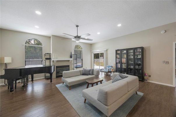 Fireplace, Interior, Living room, Piano, Recessed Lighting, Wood Texture Flooring