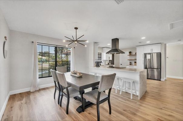 Dining room, Interior, Kitchen, Pendant Lights, Recessed Lighting, Stainless Steel Appliances, Wood Texture Flooring