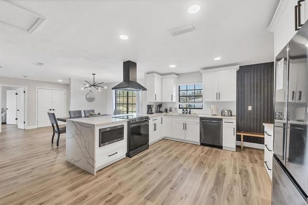 Dining room, Interior, Kitchen, Pendant Lights, Recessed Lighting, Stainless Steel Appliances, Wood Texture Flooring