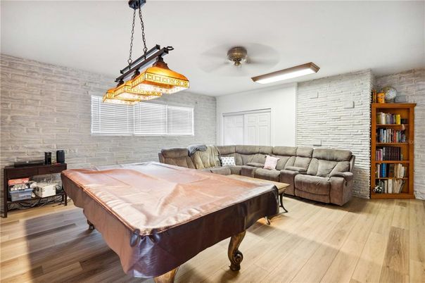 Billiard Table, Chandelier, Game Room, Interior, Living room, Pendant Lights, Stone Walls, Wood Texture Flooring