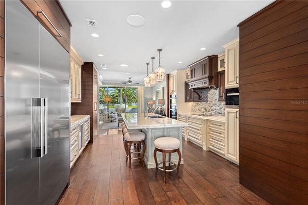 Chandelier, Dining room, Interior, Kitchen, Pendant Lights, Recessed Lighting, Stainless Steel Appliances, Wood Texture Flooring