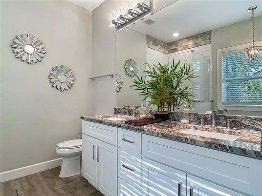 Bathroom, Dual Sink Vanities, Interior, Pendant Lights, Recessed Lighting, Wood Texture Flooring
