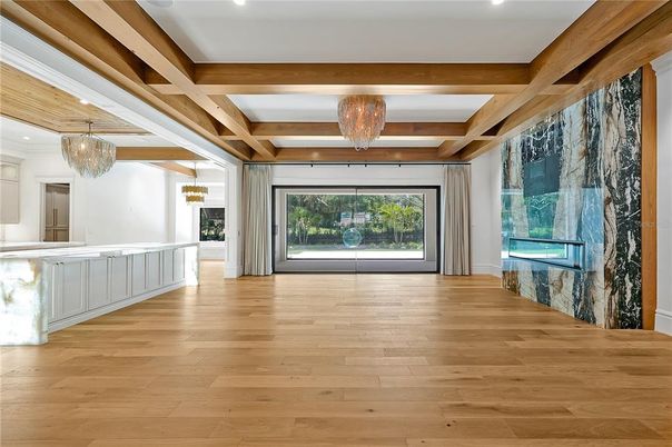 Chandelier, Empty room, Fireplace, Interior, Recessed Lighting, Wooden Beams, Wood Texture Flooring