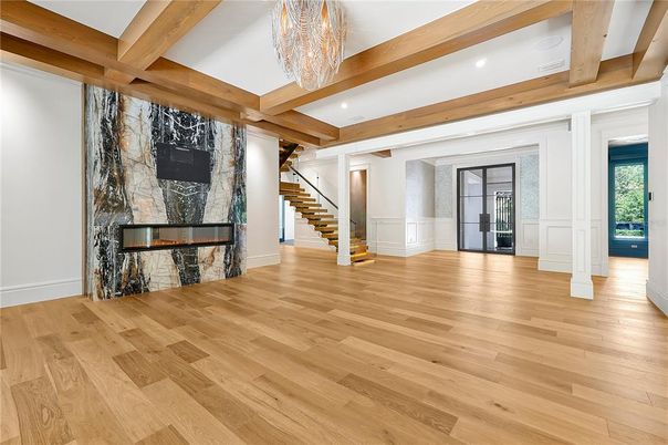 Chandelier, Empty room, Fireplace, Interior, Recessed Lighting, Wooden Beams, Wood Texture Flooring