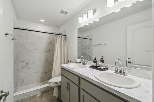 Bathroom, Dual Sink Vanities, Glass Shower, Interior, Marble Walls, Recessed Lighting
