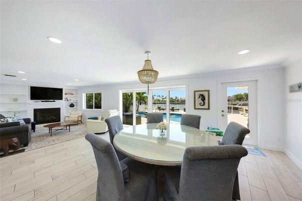 Dining room, Fireplace, Interior, Living room, Pendant Lights, Recessed Lighting, Water, Wood Texture Flooring