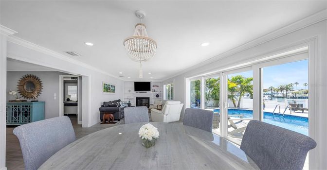 Chandelier, Dining room, Fireplace, Interior, Living room, Recessed Lighting, Water, Wood Texture Flooring