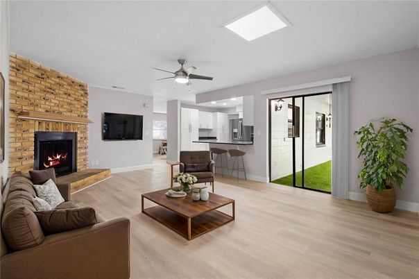 Fireplace, Interior, Kitchen, Living room, Recessed Lighting, Stainless Steel Appliances, Stone Walls, Wood Texture Flooring