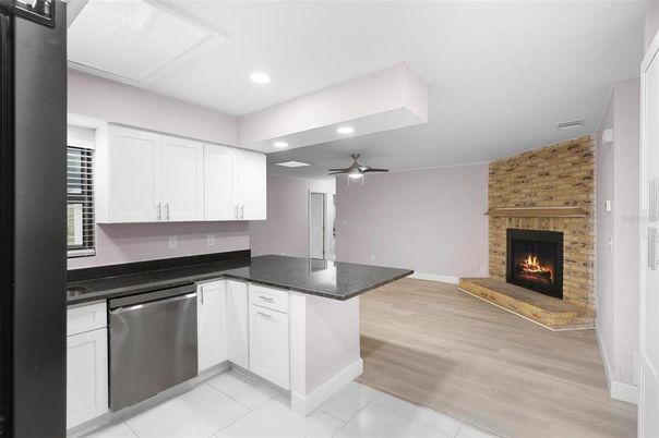 Fireplace, Interior, Kitchen, Recessed Lighting, Stone Walls, Wood Texture Flooring
