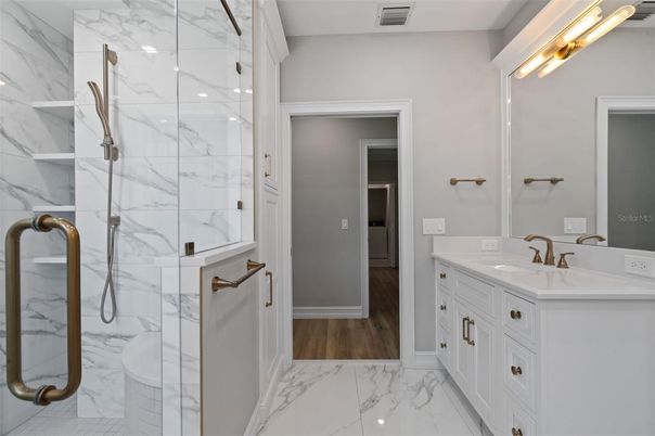 Bathroom, Dual Sink Vanities, Glass Shower, Interior, Marble, Marble Walls, Wood Texture Flooring