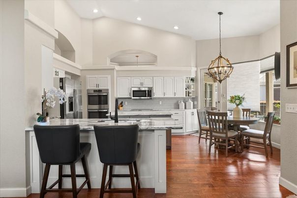 Chandelier, Dining room, Interior, Kitchen, Pendant Lights, Recessed Lighting, Stainless Steel Appliances, Wood Texture Flooring