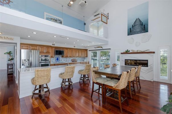 Dining room, Fireplace, Interior, Kitchen, Recessed Lighting, Stainless Steel Appliances, Wood Texture Flooring
