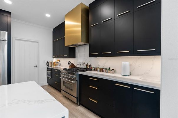 Interior, Kitchen, Marble Walls, Recessed Lighting, Stainless Steel Appliances, Wood Texture Flooring