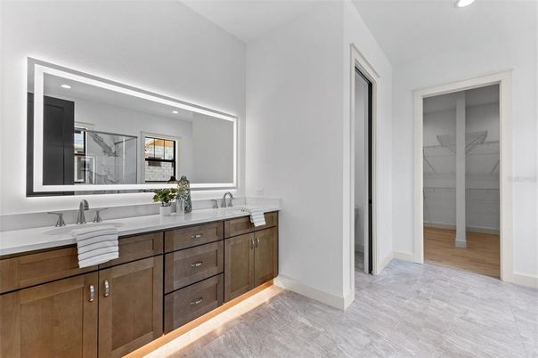 Bathroom, Dual Sink Vanities, Interior, Marble, Marble Walls, Recessed Lighting, Wood Texture Flooring