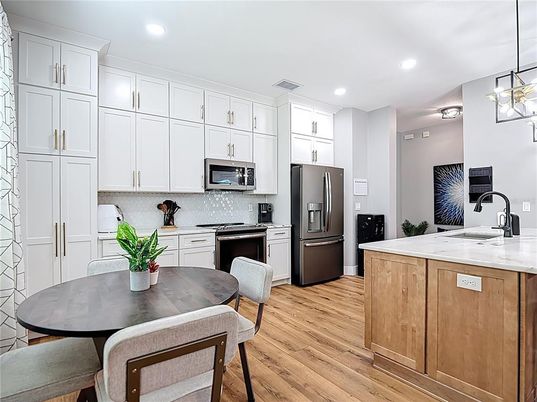 Dining room, Interior, Kitchen, Pendant Lights, Recessed Lighting, Stainless Steel Appliances, Wood Texture Flooring