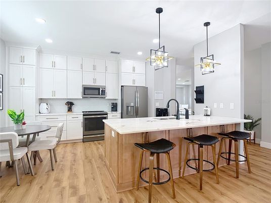 Dining room, Interior, Kitchen, Pendant Lights, Recessed Lighting, Stainless Steel Appliances, Wood Texture Flooring
