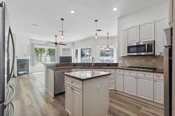Fireplace, Interior, Kitchen, Pendant Lights, Recessed Lighting, Stainless Steel Appliances, Wood Texture Flooring