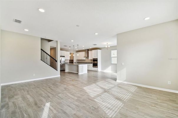 Empty room, Interior, Kitchen, Pendant Lights, Recessed Lighting, Stainless Steel Appliances, Wood Texture Flooring