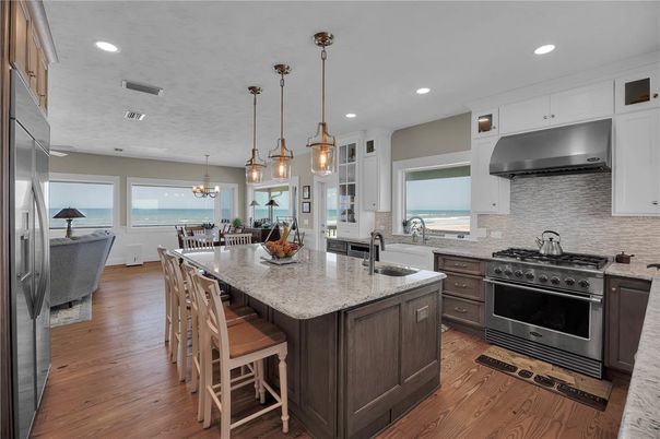 Chandelier, Dining room, Interior, Kitchen, Living room, Pendant Lights, Recessed Lighting, Stainless Steel Appliances, Water, Wood Texture Flooring