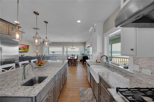 Chandelier, Dining room, Interior, Kitchen, Living room, Pendant Lights, Recessed Lighting, Stainless Steel Appliances, Wood Texture Flooring