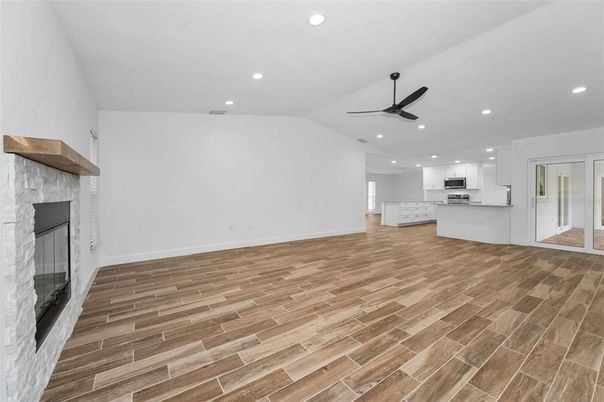 Empty room, Fireplace, Interior, Kitchen, Recessed Lighting, Wood Texture Flooring