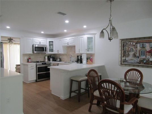 Dining room, Interior, Kitchen, Pendant Lights, Recessed Lighting, Stainless Steel Appliances, Wood Texture Flooring