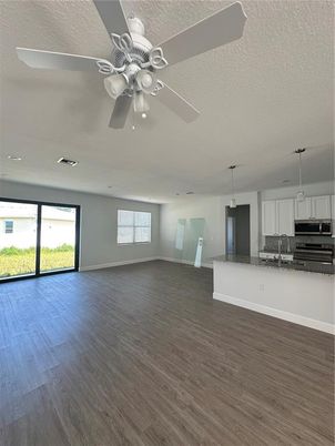 Empty room, Interior, Kitchen, Pendant Lights, Recessed Lighting, Stainless Steel Appliances, Wood Texture Flooring