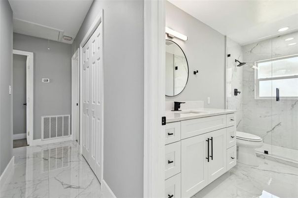 Bathroom, Dual Sink Vanities, Glass Shower, Interior, Marble, Marble Walls, Recessed Lighting