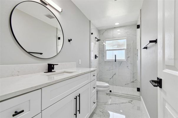 Bathroom, Dual Sink Vanities, Glass Shower, Interior, Marble, Marble Walls, Recessed Lighting