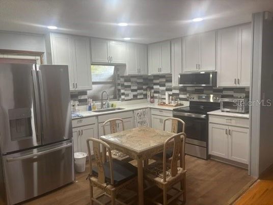Dining room, Interior, Kitchen, Recessed Lighting, Stainless Steel Appliances, Wood Texture Flooring