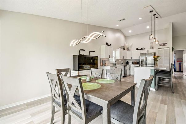 Dining room, Fireplace, Interior, Kitchen, Pendant Lights, Recessed Lighting, Stainless Steel Appliances, Wood Texture Flooring