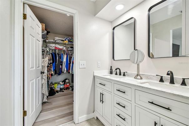 Bathroom, Dual Sink Vanities, Interior, Recessed Lighting, Walk-in Closets, Wood Texture Flooring