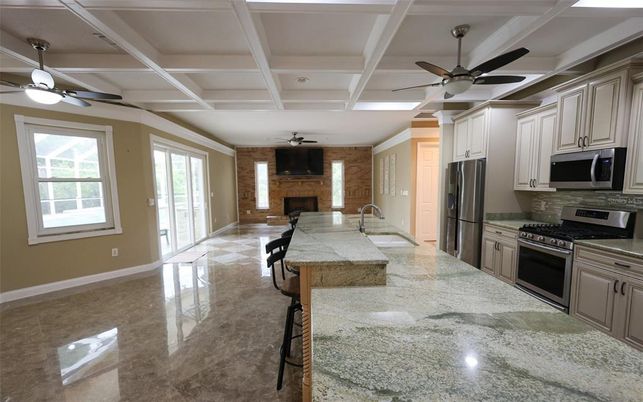 Fireplace, Interior, Kitchen, Recessed Lighting, Stainless Steel Appliances, Stone Walls