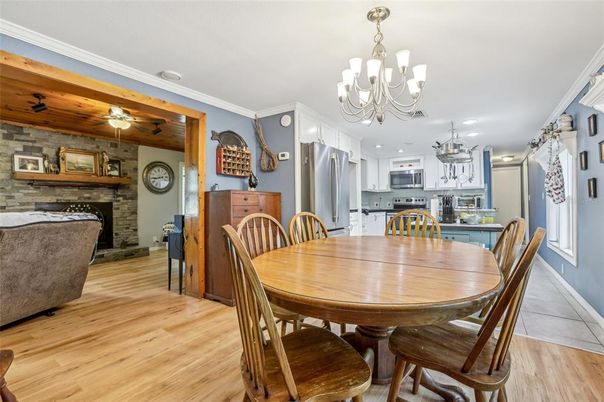Chandelier, Dining room, Fireplace, Interior, Kitchen, Stainless Steel Appliances, Stone Walls, Wood Texture Flooring