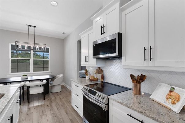 Dining room, Interior, Kitchen, Pendant Lights, Recessed Lighting, Stainless Steel Appliances, Wood Texture Flooring
