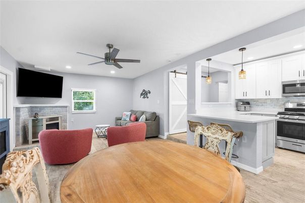 Dining room, Fireplace, Interior, Kitchen, Living room, Pendant Lights, Recessed Lighting, Stainless Steel Appliances, Wood Texture Flooring