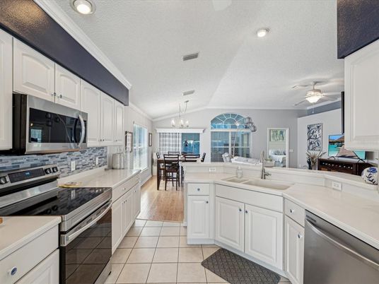 Chandelier, Dining room, Interior, Kitchen, Recessed Lighting, Stainless Steel Appliances, Wood Texture Flooring