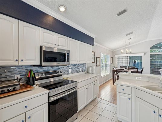 Chandelier, Dining room, Interior, Kitchen, Recessed Lighting, Stainless Steel Appliances, Wood Texture Flooring