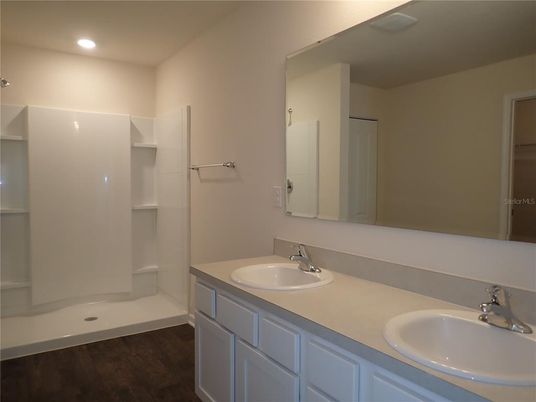 Bathroom, Dual Sink Vanities, Interior, Recessed Lighting, Walk-in Closets, Wood Texture Flooring