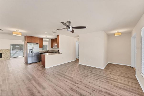 Empty room, Interior, Kitchen, Recessed Lighting, Stainless Steel Appliances, Wood Texture Flooring