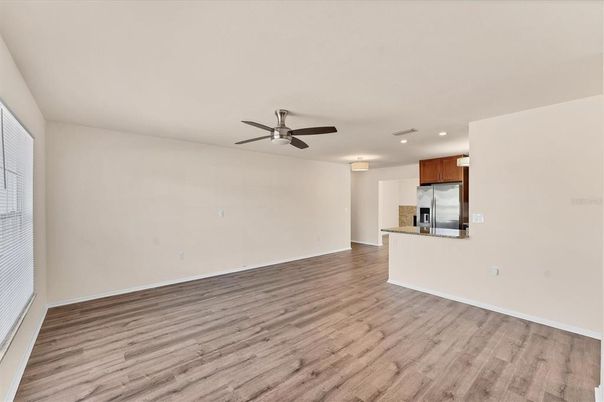 Empty room, Interior, Kitchen, Recessed Lighting, Stainless Steel Appliances, Wood Texture Flooring