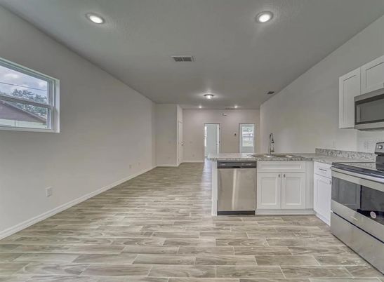 Fireplace, Interior, Kitchen, Recessed Lighting, Stainless Steel Appliances, Wood Texture Flooring